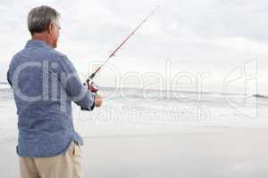 Senior man fishing in sea