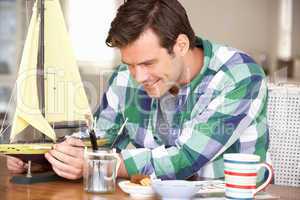 Man making model ship