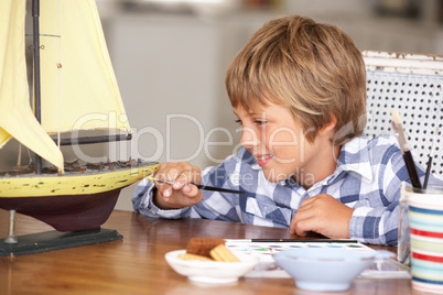 Young boy making model ship