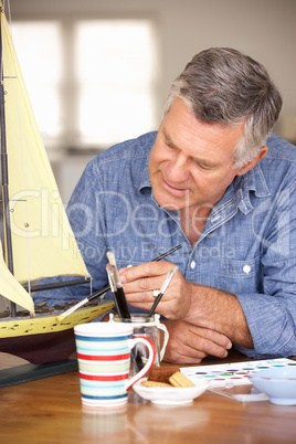 Senior man model making