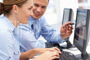 Business man and woman working on computers