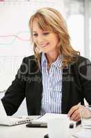 Mid age businesswoman at work