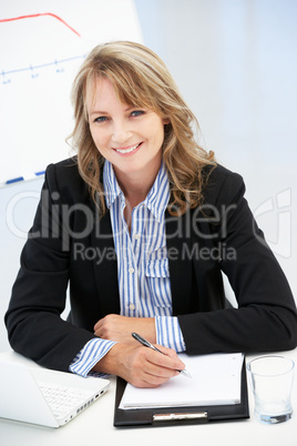 Mid age businesswoman at work