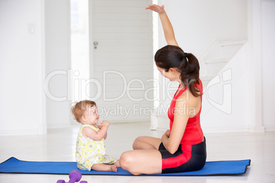 Mother and baby doing yoga