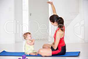 Mother and baby doing yoga