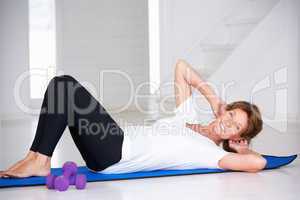 Senior woman doing curl-ups