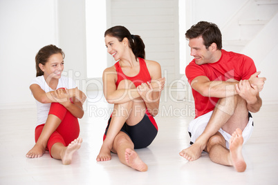 Mother,father and daughter doing yoga