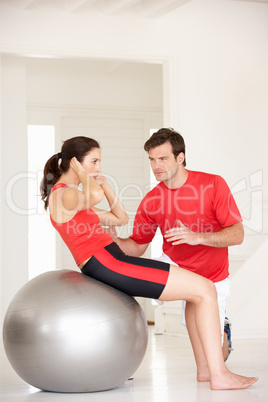 Woman with personal trainer in home gym