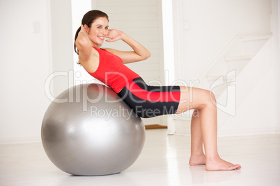 Woman with gym ball in home gym