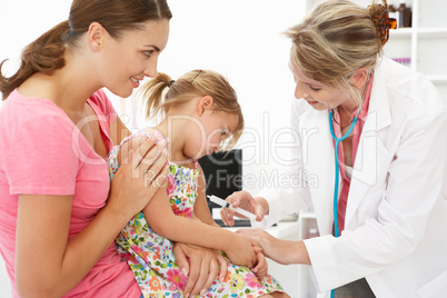 Female doctor injecting child