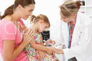 Female doctor injecting child