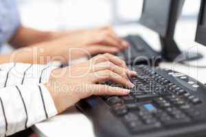 Close up businesswomen typing