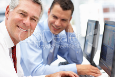 Businessmen working on computers