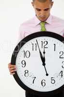 Young businessman with giant clock