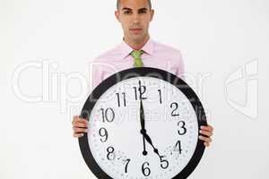 Young businessman with giant clock