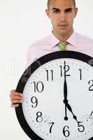 Young businessman with giant clock