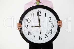 Young businessman with giant clock