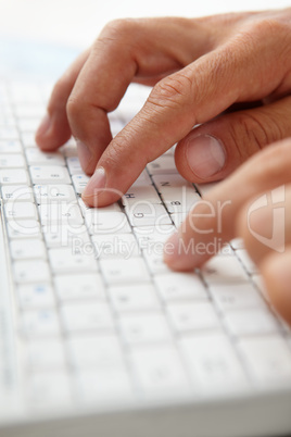 Close up man using computer keyboard