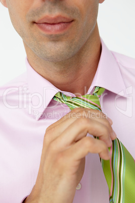 Buisnessman putting on tie