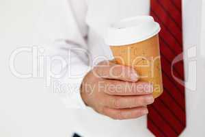 Businessman holding takeout coffee