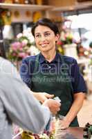 Woman serving customer in florist