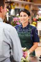 Woman serving customer in florist