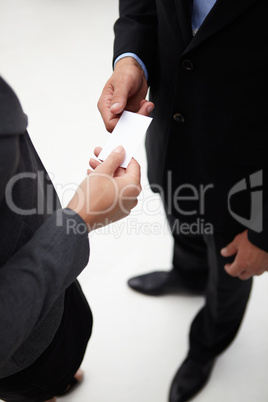 Detail businessman and woman exchanging cards