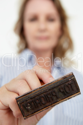 Businesswoman with rubber stamp