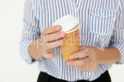 Businesswoman holding takeout coffee