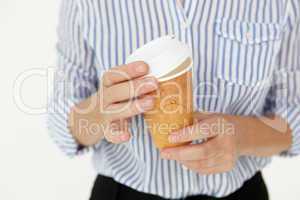 Businesswoman holding takeout coffee