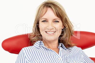 Mid age businesswoman relaxing in chair