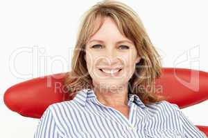 Mid age businesswoman relaxing in chair
