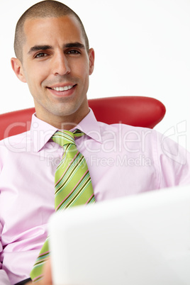 Young businessman using laptop