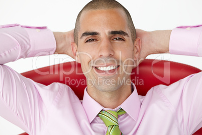Young businessman relaxing in chair