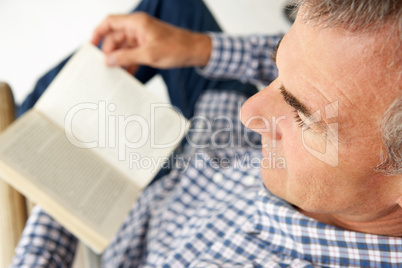 Mid age man reading a book