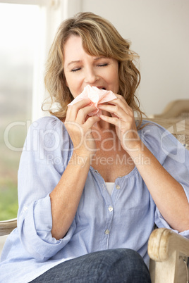 Mid age woman sneezing
