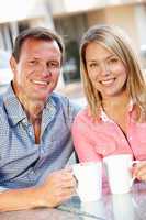 Couple sitting at sidewalk café