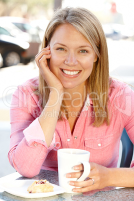 Woman sitting at sidewalk café