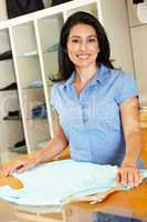 Hispanic woman working in fashion store