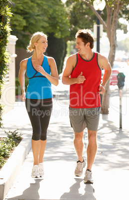 Couple running on city street