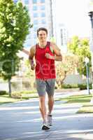 Man running in city park