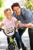 Father with boy on bike