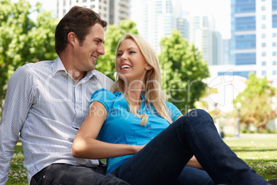 Couple sitting in city park