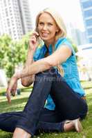Woman in city park talking on phone