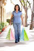 Hispanic woman carrying shopping