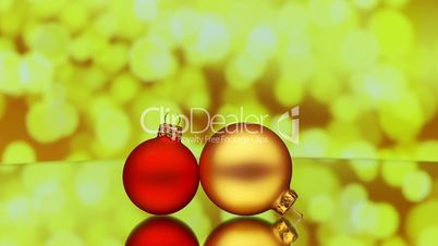 christmas baubles rotating on reflective surface