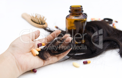 hand with pills and loss hair
