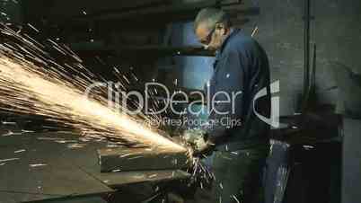 Man at work with circular blade in steel factory
