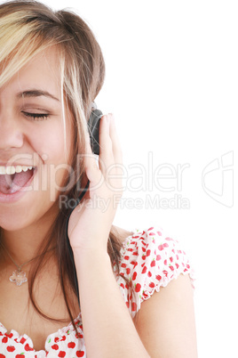 pretty casual brunette is listening to music on white background