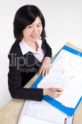 Businesswoman signing document.